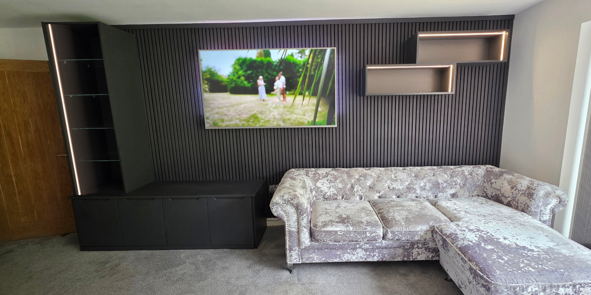 Custom black media wall in Rochdale